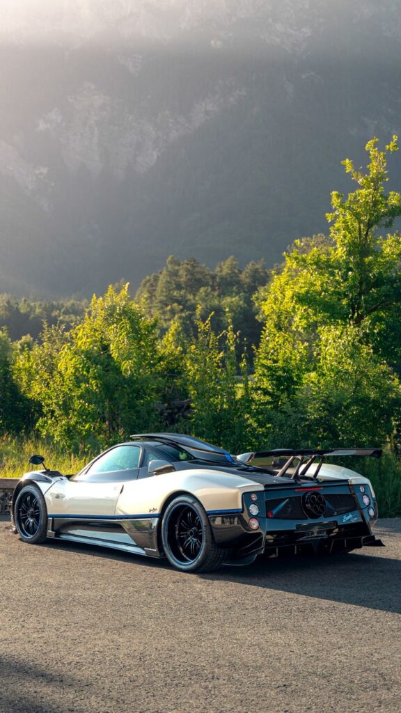 35ac952fdd8ff63388baded5a8fe06e8 Sleek sports car with aerodynamic design parked on a scenic mountain road, surrounded by lush green trees and majestic peaks. | Sky Rye Design Sleek sports car with aerodynamic design parked on a scenic mountain road, surrounded by lush green trees and majestic peaks.