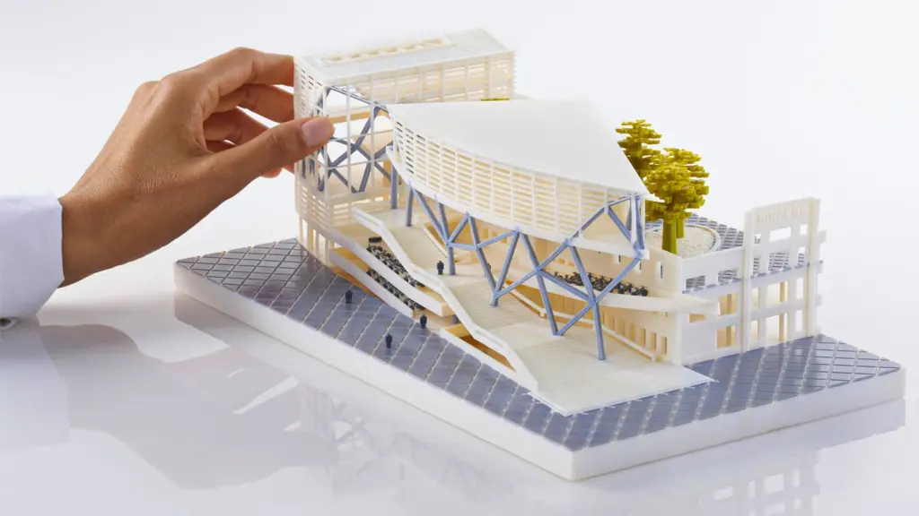 3D-architecture-model-from-purpleplatypus-dot-com Hand adjusting a modern architectural model with trees and blue supports. | Sky Rye Design Hand adjusting a modern architectural model with trees and blue supports.