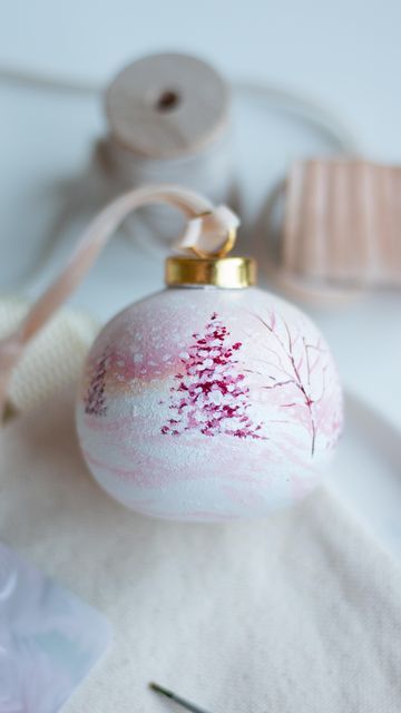 Festive Christmas ornament with hand-painted winter tree design, perfect for seasonal decoration.