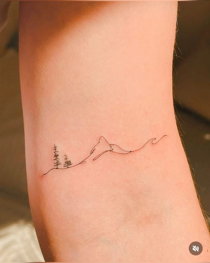 _ 4 Minimalist mountain and trees tattoo on skin, featuring subtle line art in black ink. Perfect body art inspiration for nature lovers. | Sky Rye Design Minimalist mountain and trees tattoo on skin, featuring subtle line art in black ink. Perfect body art inspiration for nature lovers.