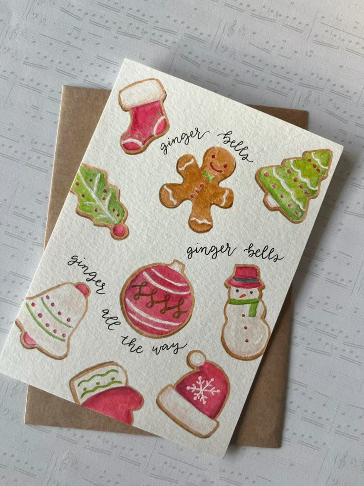 Holiday card with festive illustrated cookies, including a gingerbread man, trees, stockings, bells, and a snowman, on sheet music background.
