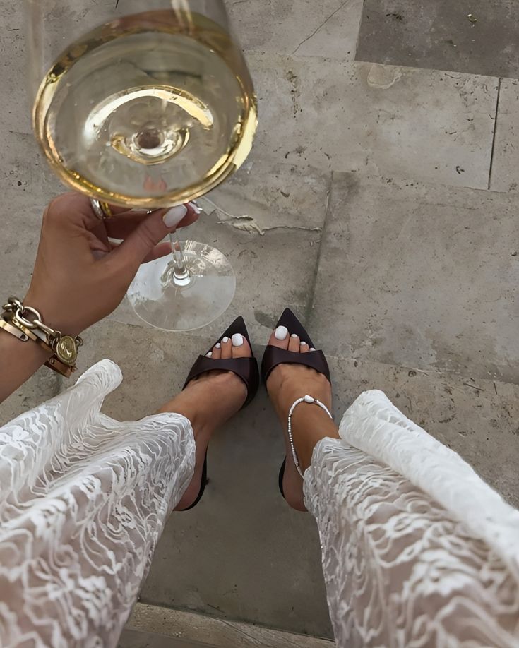 _ 42 Elegant woman in stylish lace outfit, black heels, with wine glass, enjoying a moment of sophistication and chic fashion. | Sky Rye Design Elegant woman in stylish lace outfit, black heels, with wine glass, enjoying a moment of sophistication and chic fashion.