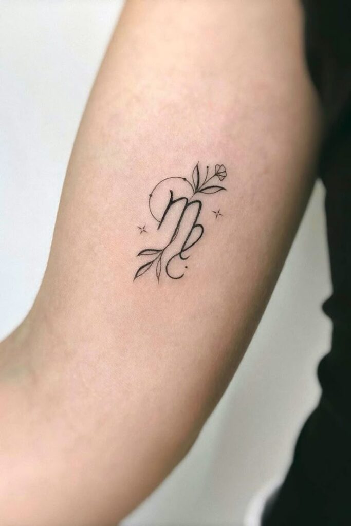 Elegant floral Virgo tattoo on forearm, featuring delicate leaves and stars, symbolizing grace and astrology-inspired design.