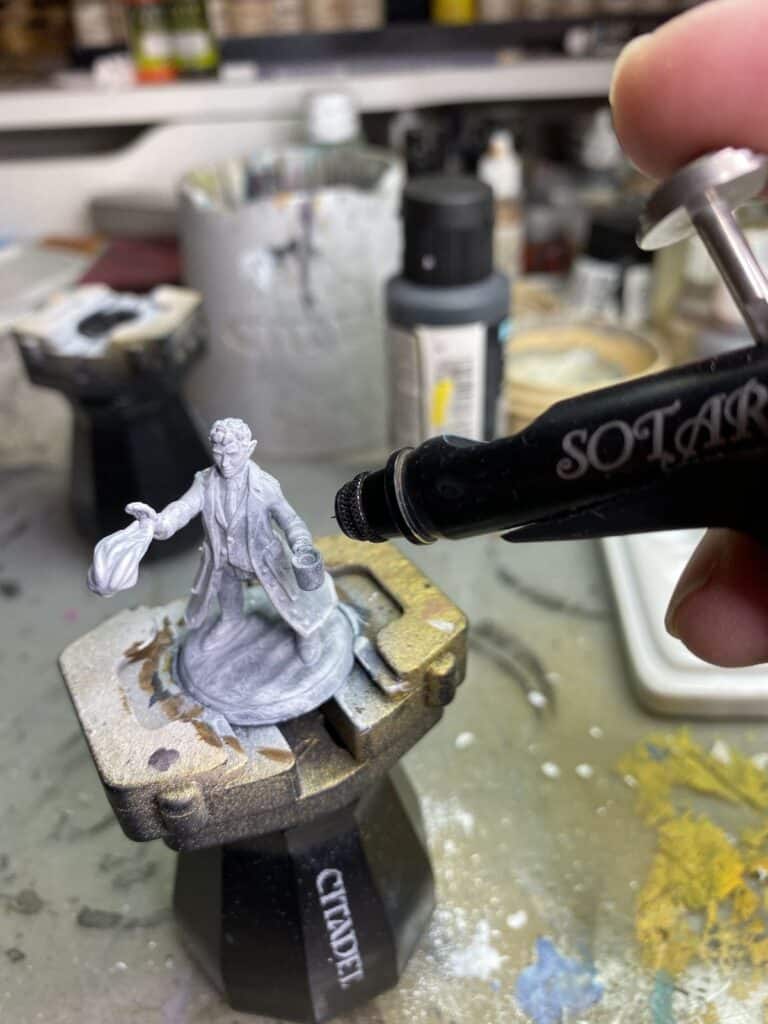4c0dbe688a4fe68a0ea52d1813c2dbaf Airbrush painting miniature figurine on a stand, detail work in progress. | Sky Rye Design Airbrush painting miniature figurine on a stand, detail work in progress.