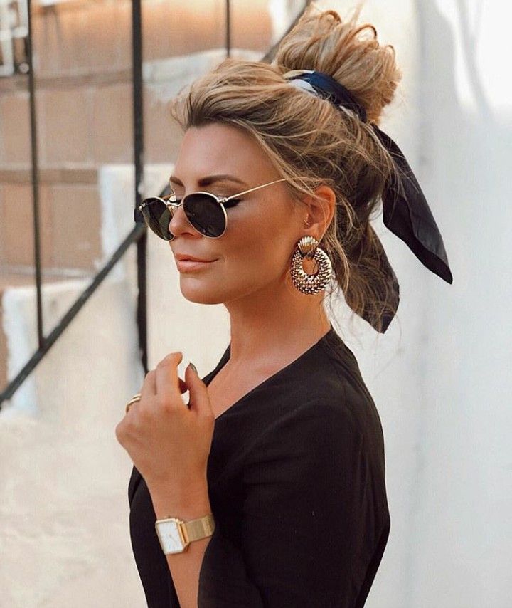 _ 5 Stylish woman with sunglasses and earrings, wearing a black top and gold watch, hair in a bun with a ribbon. | Sky Rye Design Stylish woman with sunglasses and earrings, wearing a black top and gold watch, hair in a bun with a ribbon.