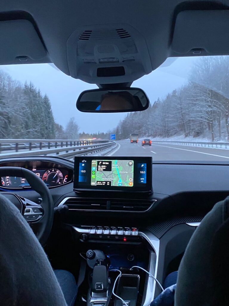 516dd65249fee2439fd8a19b55fb6839 View from inside a car on a snowy highway, featuring a GPS navigation screen with route details. | Sky Rye Design View from inside a car on a snowy highway, featuring a GPS navigation screen with route details.