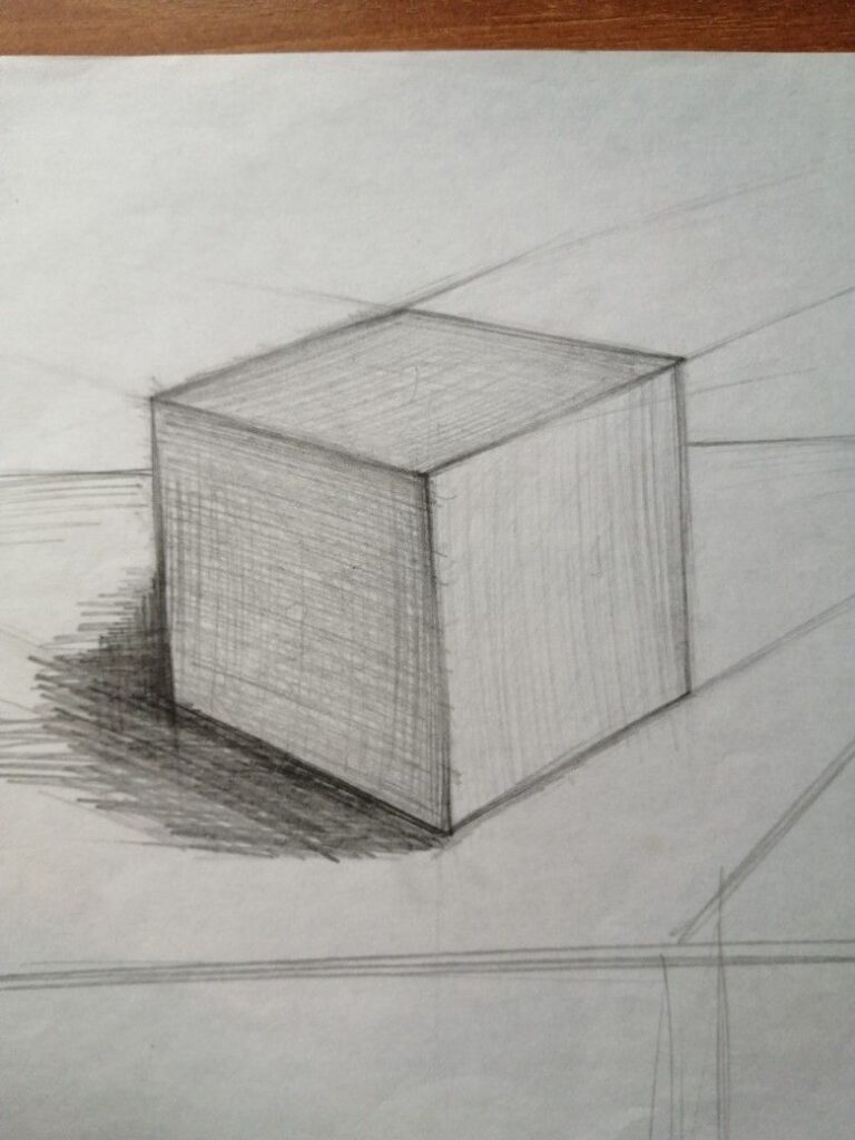 Pencil sketch of a 3D cube with shading, showcasing basic perspective drawing and shadow techniques on a white background.