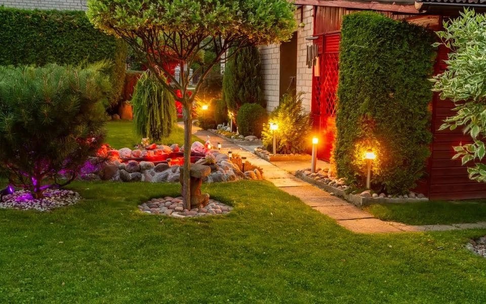 5249468497471934267 Illuminated garden pathway with vibrant plants, glowing lights, and a serene landscaped pond, creating a tranquil outdoor retreat. | Sky Rye Design Illuminated garden pathway with vibrant plants, glowing lights, and a serene landscaped pond, creating a tranquil outdoor retreat.