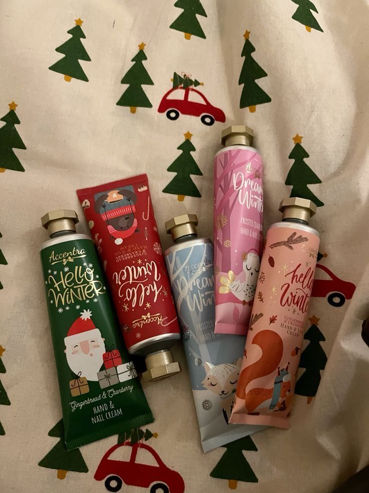 _ 54 Holiday-themed hand cream tubes on festive fabric with cars and trees. Perfect winter gift idea for nourishing skin in cold weather. | Sky Rye Design Holiday-themed hand cream tubes on festive fabric with cars and trees. Perfect winter gift idea for nourishing skin in cold weather.