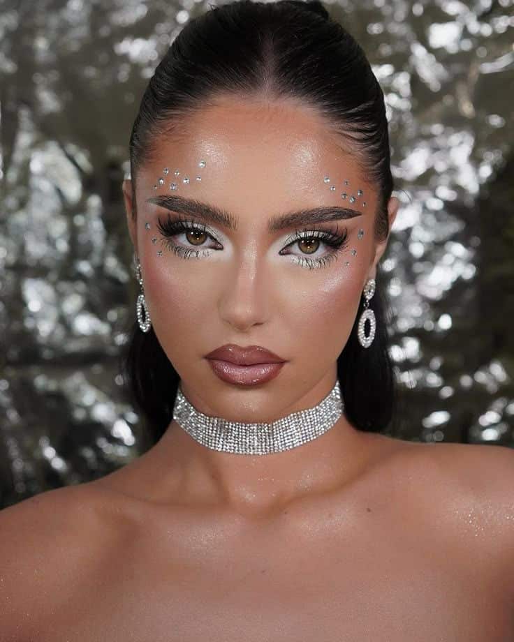 Glamorous makeup look with sparkling eye embellishments, diamond choker, and statement earrings. Perfect for festive occasions and parties.