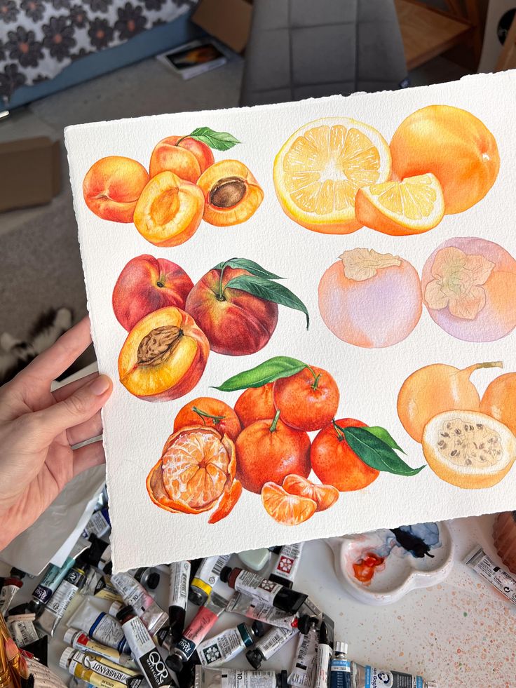 5d4f4c16-cf13-42d9-97d7-f3bc4546aee1 Hand-painted fruit illustration featuring peaches, oranges, and persimmons on paper, with art supplies in the background. Vibrant and detailed. | Sky Rye Design Hand-painted fruit illustration featuring peaches, oranges, and persimmons on paper, with art supplies in the background. Vibrant and detailed.