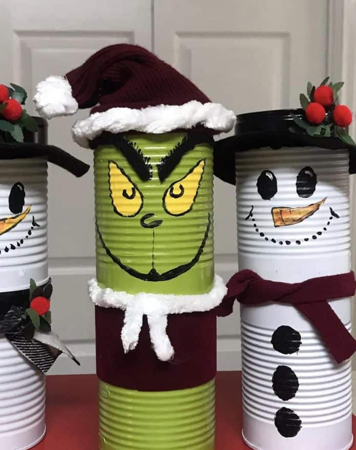 616cb7be4295776de23a452f3431f73e Decorative tin cans painted as holiday characters: Grinch in a Santa hat and snowmen with scarves and hats, perfect for Christmas decor. | Sky Rye Design Decorative tin cans painted as holiday characters: Grinch in a Santa hat and snowmen with scarves and hats, perfect for Christmas decor.