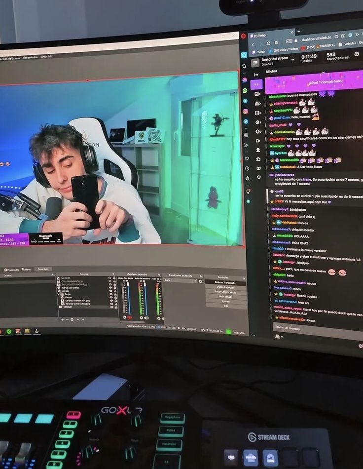 Streamer on screen with gaming setup, live chat, and audio controls in view, engaging in an online Twitch broadcast session.