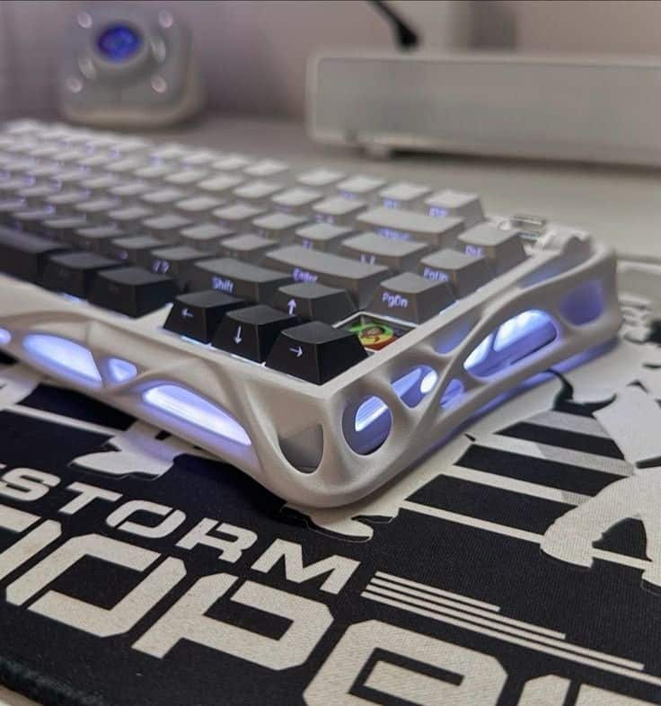 _ 7 Futuristic mechanical keyboard with glowing keys on a branded gaming mat, showcasing an ergonomic design and customizable backlighting. | Sky Rye Design Futuristic mechanical keyboard with glowing keys on a branded gaming mat, showcasing an ergonomic design and customizable backlighting.