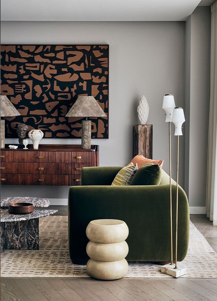 _ 7 Stylish living room with green velvet sofa, modern art, wooden sideboard, and marble coffee table. | Sky Rye Design Stylish living room with green velvet sofa, modern art, wooden sideboard, and marble coffee table.