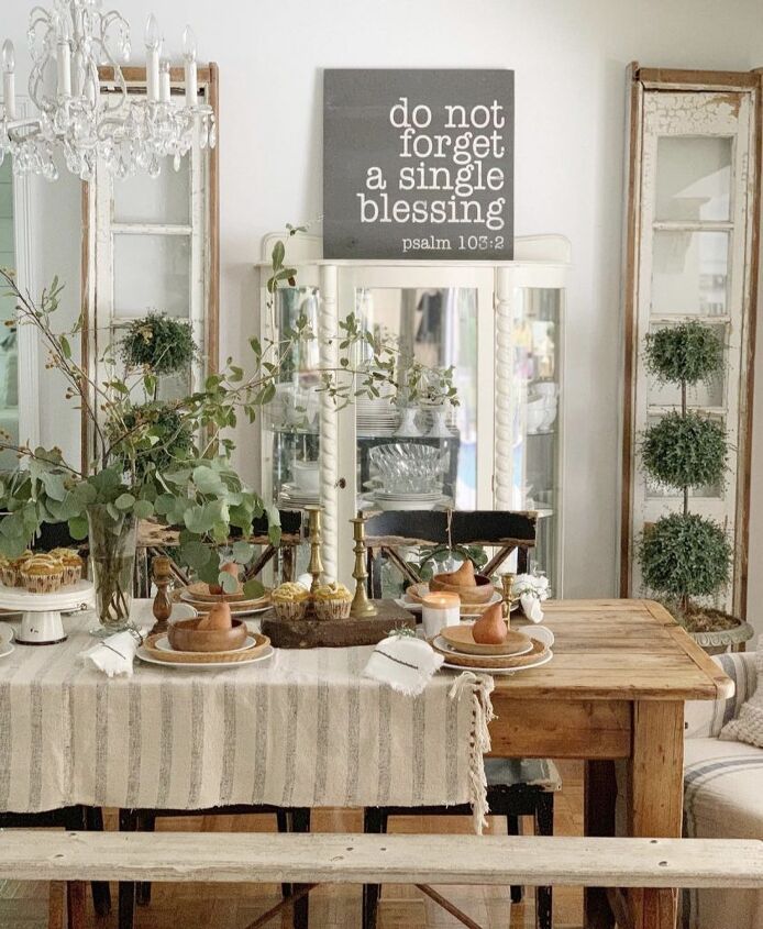 7 Useful Fall Decor Items You Need to Thrift For Rustic dining room with a wooden table set for a meal, adorned with candles and greenery, under a sign with a blessing. | Sky Rye Design Rustic dining room with a wooden table set for a meal, adorned with candles and greenery, under a sign with a blessing.