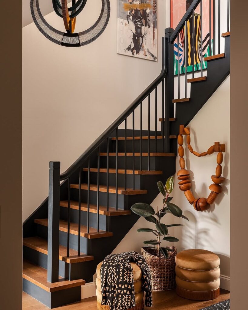 75bd20f2e5ae83a0fbeecba936d4eab8 Modern staircase with wooden steps, black railing, and wall art; decorative basket and plant at the base. | Sky Rye Design Modern staircase with wooden steps, black railing, and wall art; decorative basket and plant at the base.
