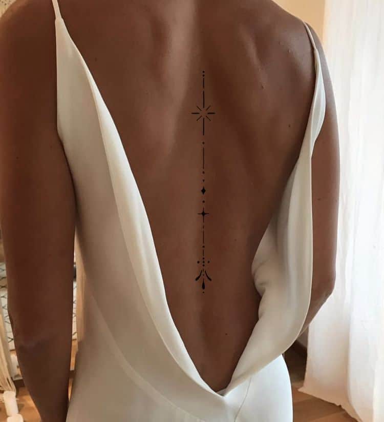 7902f8313946f4b64f53fb5d6a6b6371 Backless dress with a geometric spine tattoo design on a woman's back, showcasing elegance and minimalistic beauty. | Sky Rye Design Backless dress with a geometric spine tattoo design on a woman's back, showcasing elegance and minimalistic beauty.