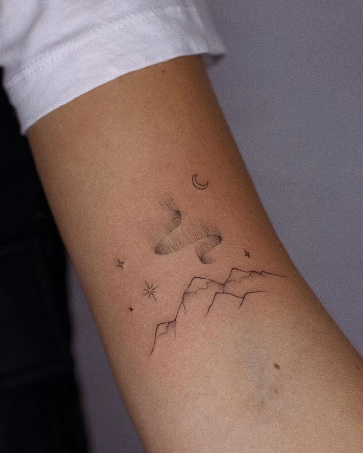 79c7f002d5f73684e928463dc4b4800b Minimalist tattoo featuring mountains, stars, crescent moon, and abstract design on an arm. | Sky Rye Design Minimalist tattoo featuring mountains, stars, crescent moon, and abstract design on an arm.