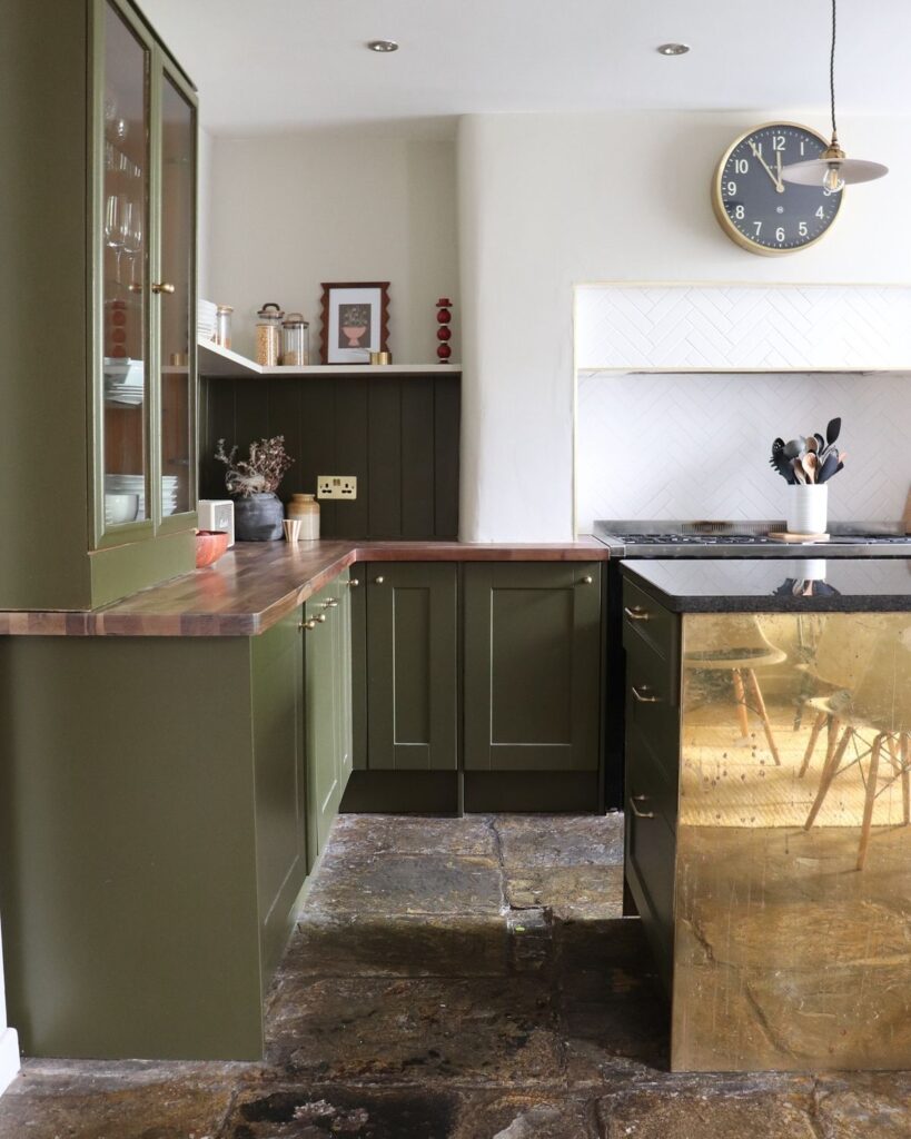 7e435cf9ab94e334eb8aa196598e212a Modern kitchen with olive green cabinets, brass island, and wall clock, showcasing stylish design elements. | Sky Rye Design Modern kitchen with olive green cabinets, brass island, and wall clock, showcasing stylish design elements.