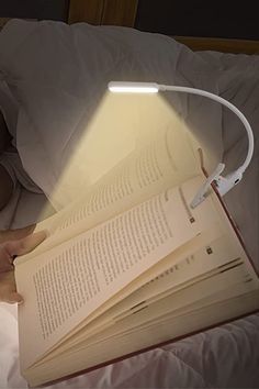 86lux Reading Light Rechargeable Book Light for Reading in Bed A book page illuminated by a flexible LED reading light, perfect for nighttime reading in bed. | Sky Rye Design A book page illuminated by a flexible LED reading light, perfect for nighttime reading in bed.