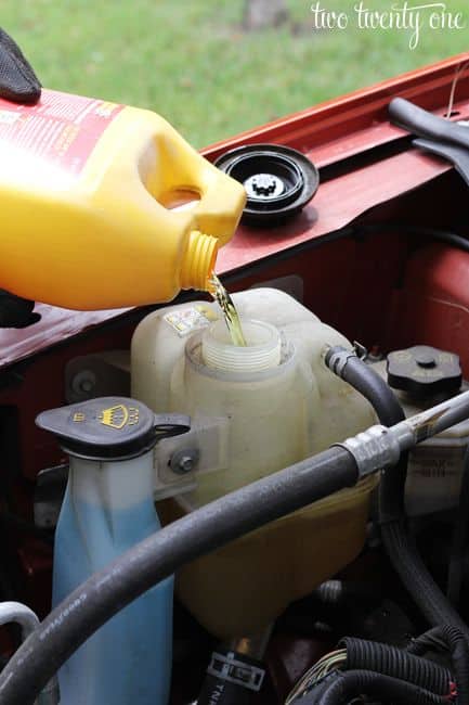 87425b908e144b6cd28e69839aeff653 Pouring antifreeze into a car's coolant reservoir for engine maintenance, ensuring optimal vehicle performance and temperature regulation. | Sky Rye Design Pouring antifreeze into a car's coolant reservoir for engine maintenance, ensuring optimal vehicle performance and temperature regulation.