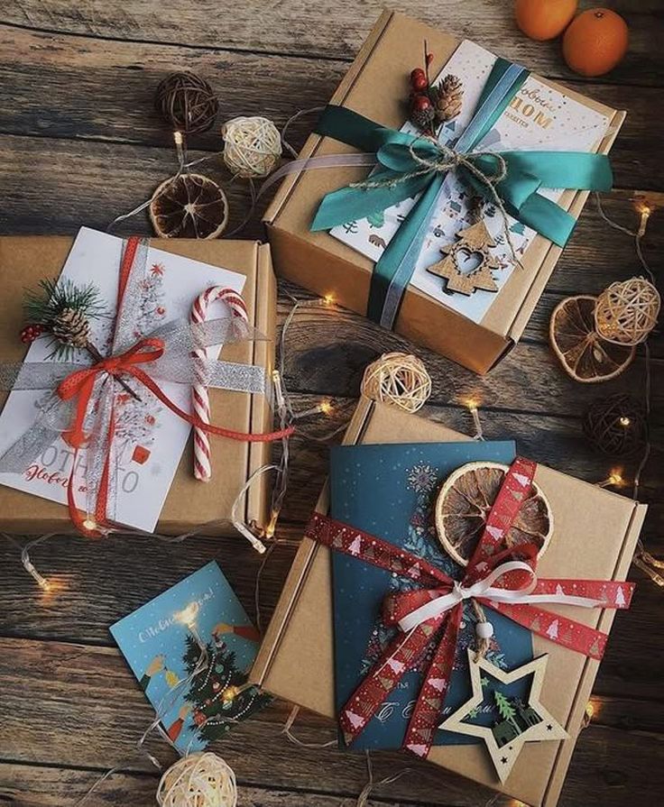 87c589d5-61bf-46ab-9981-cc5567eac706 Beautifully wrapped Christmas gift boxes with festive decorations and fairy lights on a rustic wooden table. | Sky Rye Design Beautifully wrapped Christmas gift boxes with festive decorations and fairy lights on a rustic wooden table.