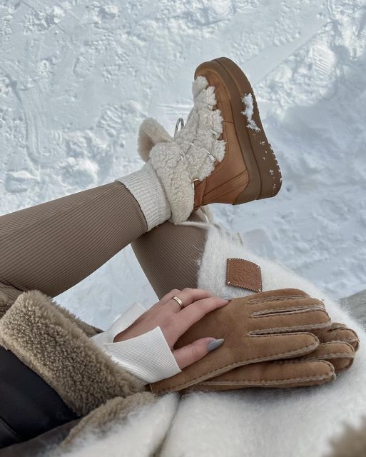 Cozy winter fashion: beige boots in snow, ribbed leggings, shearling coat, and suede gloves, perfect for cold weather style.