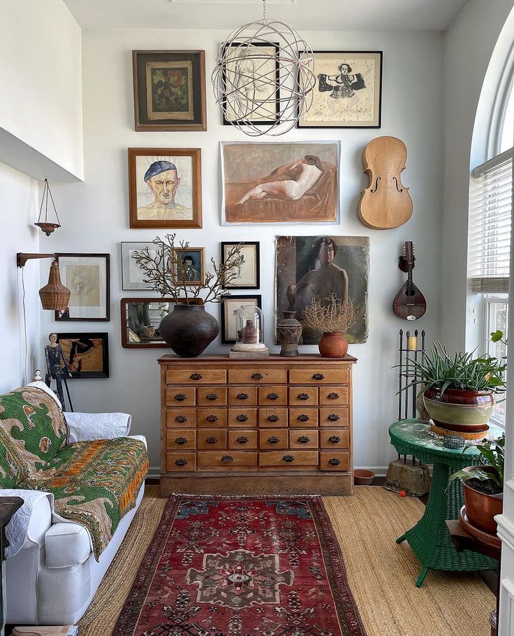 _ 9 Eclectic living room with vintage art, wooden dresser, plants, and a colorful rug for a cozy bohemian feel. | Sky Rye Design Eclectic living room with vintage art, wooden dresser, plants, and a colorful rug for a cozy bohemian feel.