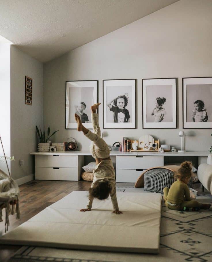 _ 9 Children playing in a cozy living room with wall art, a soft mat, and toys, creating a playful and inviting atmosphere. | Sky Rye Design Children playing in a cozy living room with wall art, a soft mat, and toys, creating a playful and inviting atmosphere.