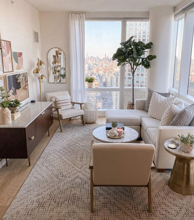 Modern living room with stylish decor, cozy furniture, large windows, and city skyline view, creating a serene and inviting atmosphere.