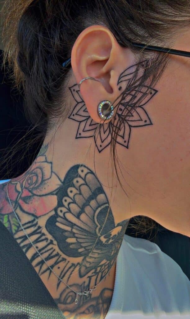 960deca3084f82ab07402f39d75168ce Woman's ear with mandala and butterfly tattoos, showcasing stylish earrings and detailed ink art. | Sky Rye Design Woman's ear with mandala and butterfly tattoos, showcasing stylish earrings and detailed ink art.