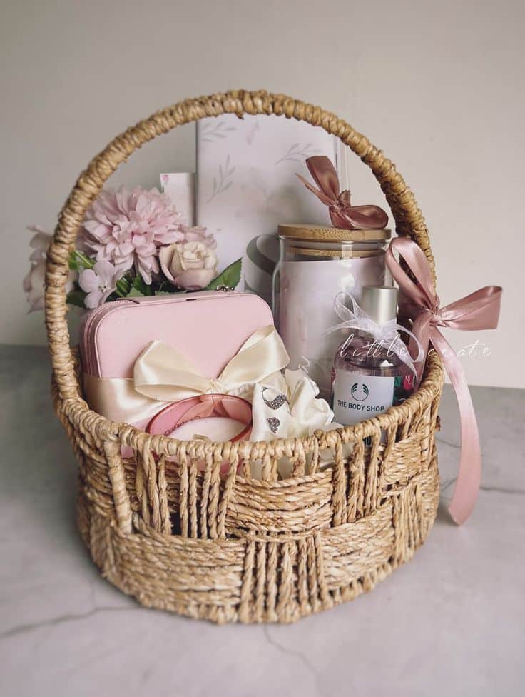 A pink birthday hamper curated with everything she Gift basket with flowers, candles, and skincare products, wrapped in elegant ribbons. Perfect for special occasions and celebrations. | Sky Rye Design Gift basket with flowers, candles, and skincare products, wrapped in elegant ribbons. Perfect for special occasions and celebrations.