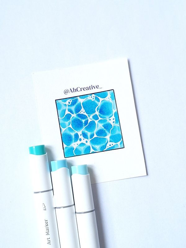 Blue abstract art square with markers on white paper, creating a unique bubble pattern.