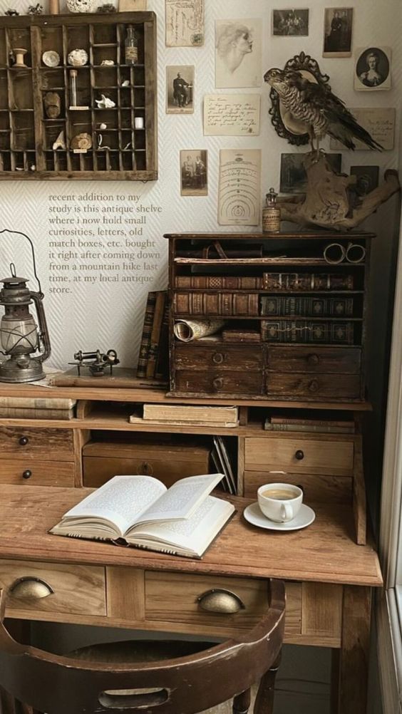 Vintage study nook with antique shelf, wooden desk, open book, and coffee cup, featuring curiosities and vintage wall decor.