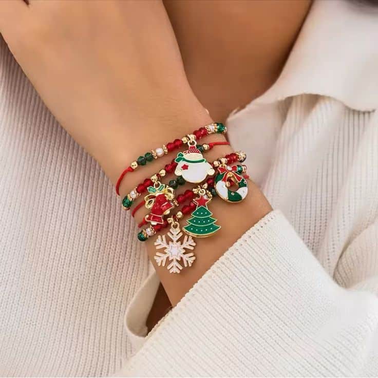 Anthropologie Jewelry _ Christmas Series Pendant Crystal Bracelet _ Color_ Green_Red _ Size_ Os Festive Christmas charm bracelets with snowflakes, trees, and Santa designs on a wrist wearing a cozy white sweater. | Sky Rye Design Festive Christmas charm bracelets with snowflakes, trees, and Santa designs on a wrist wearing a cozy white sweater.
