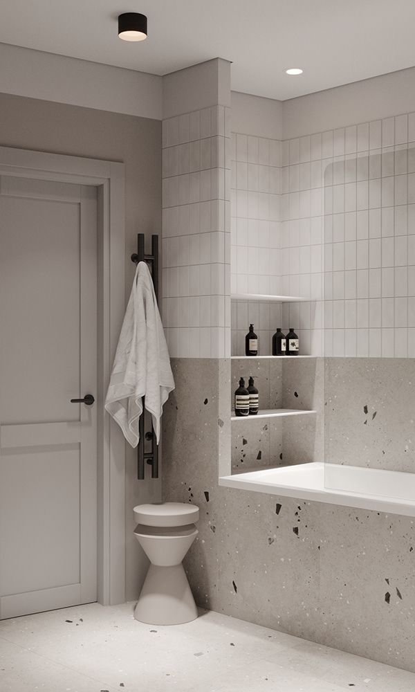 Minimalist bathroom with white tiles, sleek fixtures, and elegant decor elements, featuring a towel and modern shelving.