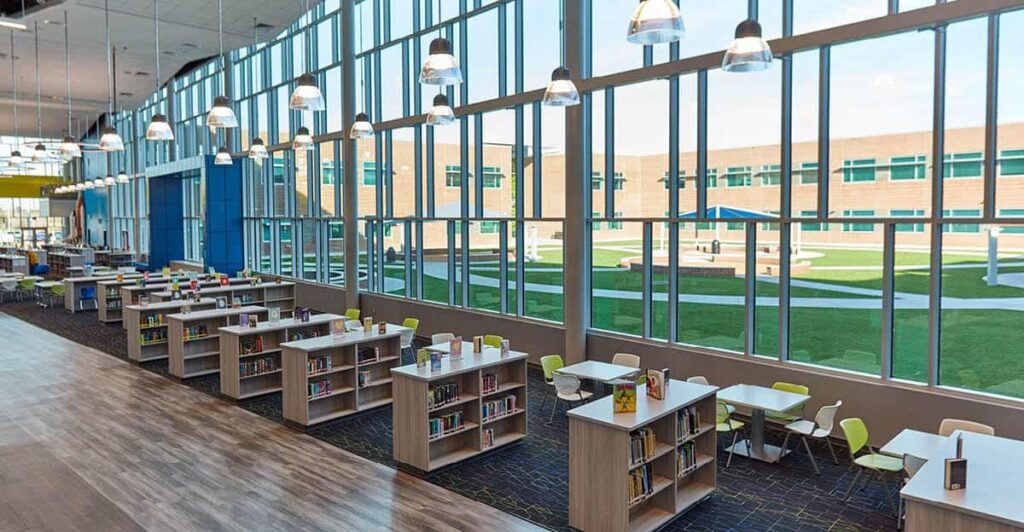 Blog-Image-Template-1200x624 Modern library interior with tall windows, bookshelves, and seating, overlooking a courtyard. Bright and spacious educational setting. | Sky Rye Design Modern library interior with tall windows, bookshelves, and seating, overlooking a courtyard. Bright and spacious educational setting.