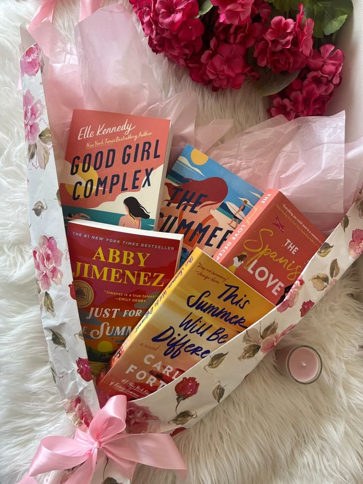 Book Bouquet ONLY BOOKS Romantic novels wrapped in floral paper with pink flowers and candle on a soft white surface, perfect for summer reading vibes. | Sky Rye Design Romantic novels wrapped in floral paper with pink flowers and candle on a soft white surface, perfect for summer reading vibes.