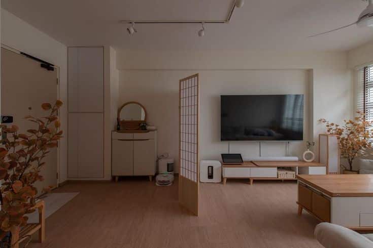 Bye Bye Busybodies_ 11 Entryway Partition Ideas for Privacy at Home Minimalist living room with wooden furniture, large TV, and decorative plants. Modern design with warm lighting. | Sky Rye Design Minimalist living room with wooden furniture, large TV, and decorative plants. Modern design with warm lighting.