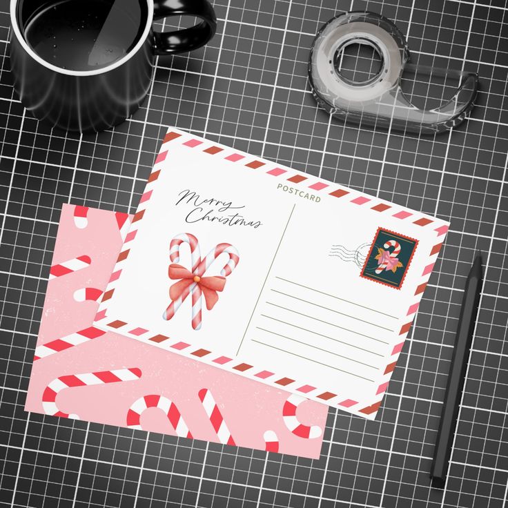 Christmas postcard with candy canes, festive envelope, tape, and pen on a grid background. Text reads Merry Christmas. Ideal for holiday greetings.