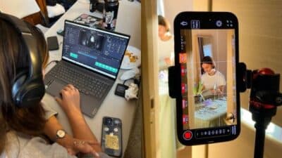 Person editing video on laptop and smartphone, showcasing video production workflow.