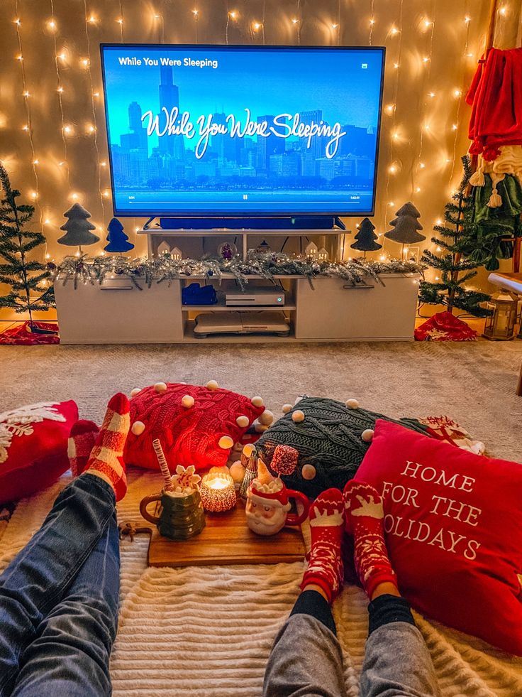 Cozy holiday movie night with festive decor and warm socks, watching While You Were Sleeping on TV.