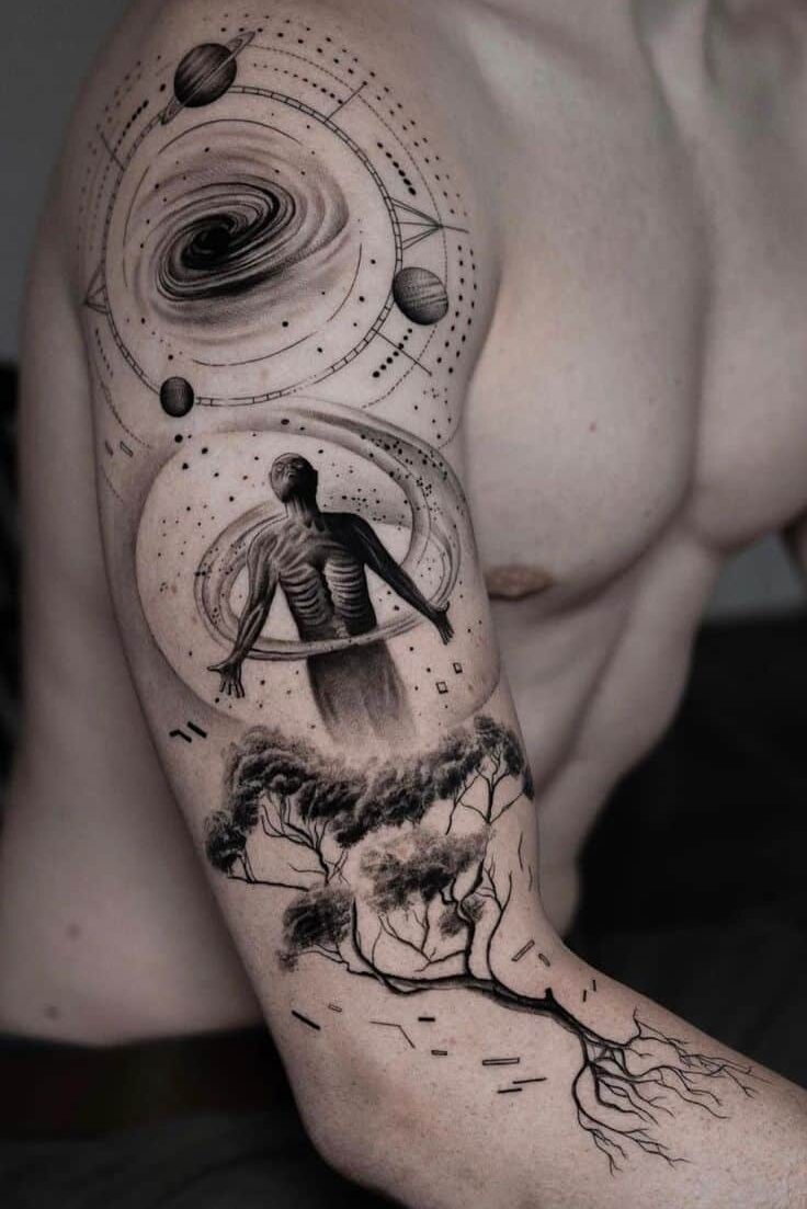 Arm with detailed cosmic tattoo featuring planets, a swirling vortex, a human figure, and tree roots.