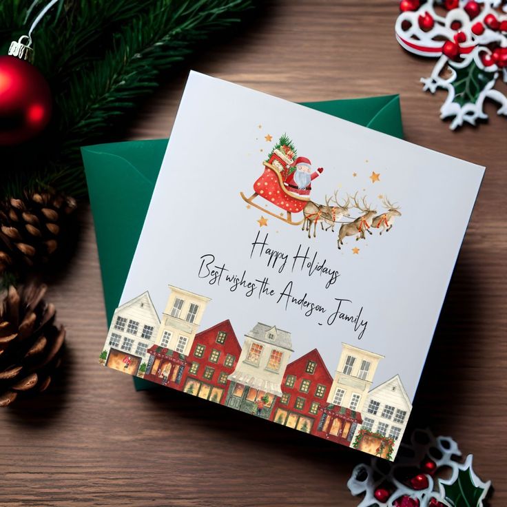 Festive holiday card with Santa's sleigh and reindeer, reading Happy Holidays from the Anderson family. Pine cones and decor surround.