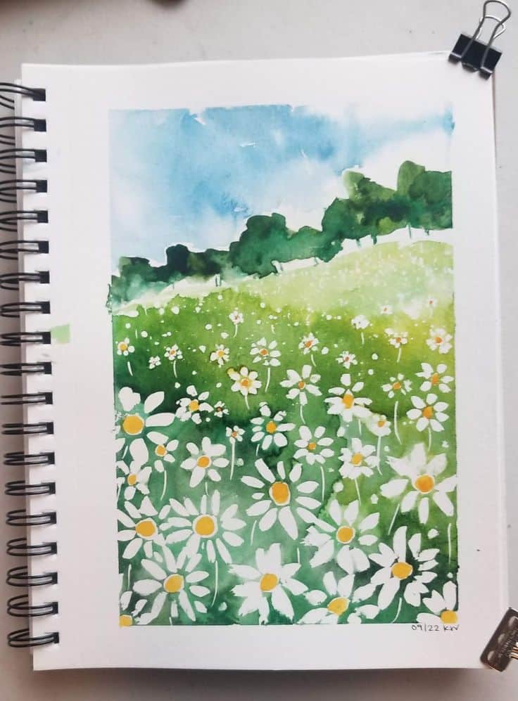 Daisy field by Katie Watters Watercolor painting of a daisy flower field under a blue sky, captured in a spiral-bound sketchbook. | Sky Rye Design Watercolor painting of a daisy flower field under a blue sky, captured in a spiral-bound sketchbook.