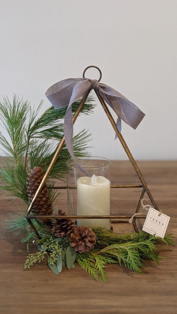 Decorated Holiday candle holder with Candle Decorative candle holder with pinecones, greenery, and a ribbon, perfect for holiday table centerpiece. | Sky Rye Design Decorative candle holder with pinecones, greenery, and a ribbon, perfect for holiday table centerpiece.