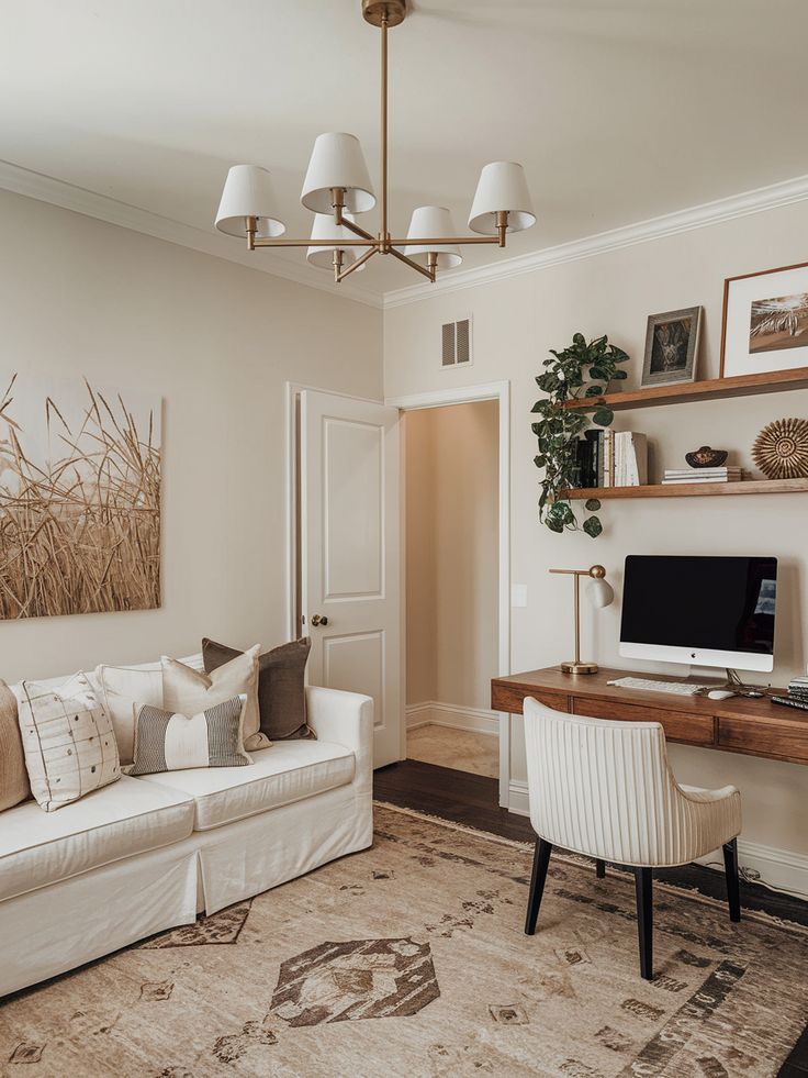 Designing a Practical Office and Guest Room Combo Stylish home office with cozy beige decor, white sofa, wooden desk, and modern computer setup. | Sky Rye Design Stylish home office with cozy beige decor, white sofa, wooden desk, and modern computer setup.