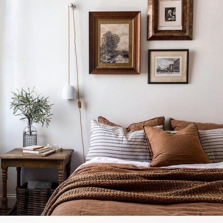Divinely delectable Sleep in our linen at mia_casa_daylesford _ The perfect retreat to discover rest and recharge 📸 danny_wootton and Cozy bedroom with brown bedding, striped pillows, wall art, and a small wooden table with plant and books. | Sky Rye Design Cozy bedroom with brown bedding, striped pillows, wall art, and a small wooden table with plant and books.