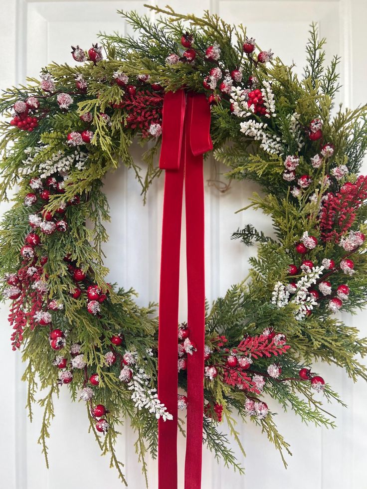 Evergreen and berry Christmas wreath Festive holiday wreath with red bow, pine branches, berries, and white accents, perfect for Christmas door decoration. | Sky Rye Design Festive holiday wreath with red bow, pine branches, berries, and white accents, perfect for Christmas door decoration.